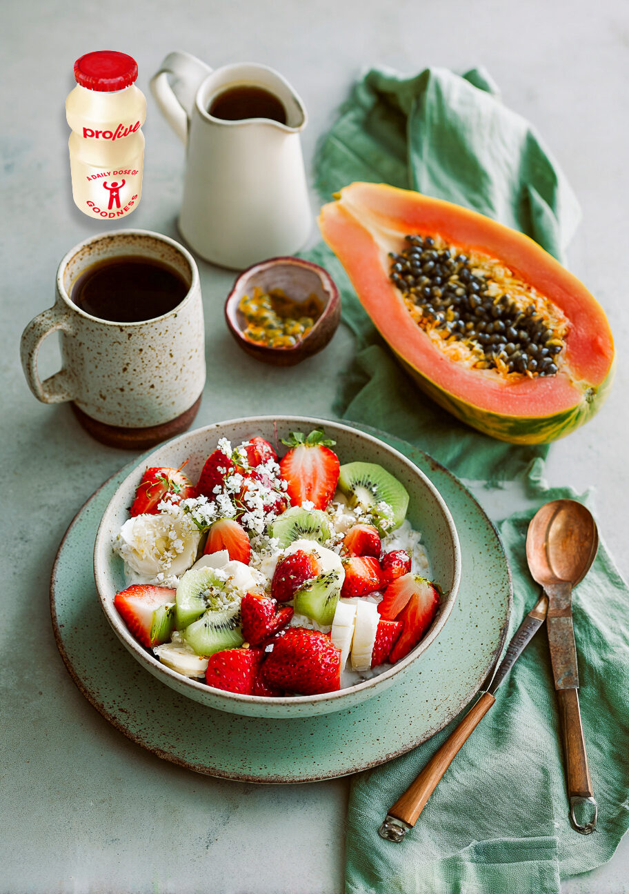 Breakfast table with fruit, yoghurt and a ProLive bottle